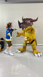 animated claws cosplay digimon goggles goggles_on_head greymon greymon_(cosplay) hug photo_(medium) real_life sharp_teeth sound teeth video yagami_taichi yagami_taichi_(cosplay)