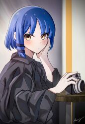 Rule 34 | 1girl, absurdres, black shirt, blue hair, bocchi the rock!, camera, chinese commentary, closed mouth, collared shirt, commentary request, hair ornament, hairpin, hand on own cheek, hand on own face, highres, holding, holding camera, humany, indoors, light blush, long sleeves, looking at viewer, medium hair, oversized clothes, shirt, signature, solo, table, upper body, wide sleeves, yamada ryo, yellow eyes