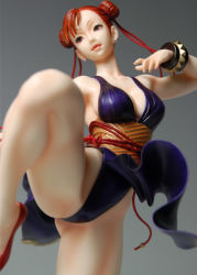 Rule 34 | 1girl, alternate costume, bare shoulders, braid, breasts, capcom, china dress, chinese clothes, chun-li, cleavage, dress, female focus, figure, kicking, large breasts, legs up, photo (medium), short hair, sideboob, solo, street fighter, street fighter iv (series)