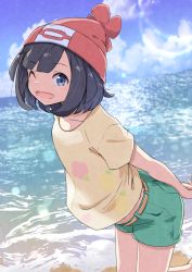 Rule 34 | 1girl, ;d, absurdres, arms behind back, beach, beanie, belt, black hair, blue eyes, blue sky, cloud, creatures (company), day, floral print, foot up, from side, game freak, green shorts, hat, highres, leaning forward, looking at viewer, negimiso1989, nintendo, ocean, one eye closed, open mouth, outdoors, own hands together, pokemon, pokemon sm, red hat, selene (pokemon), shirt, short hair, short shorts, shorts, sky, smile, solo, standing, standing on one leg, t-shirt, water, yellow belt, yellow shirt
