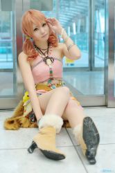 Rule 34 | 1girl, beads, belt, boots, bracelet, cosplay, door, female focus, final fantasy, final fantasy xiii, high heels, jewelry, looking at viewer, midriff, necklace, oerba dia vanille, oerba dia vanille (cosplay), on floor, pink shirt, shirt, sitting, skirt, solo, twintails, window