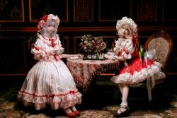 Rule 34 | 2girls, ascot, bat wings, blonde hair, board game, bobby socks, brooch, chess, chess piece, chessboard, chitandaneko, closed mouth, cosplay photo, crystal, cup, dress, flandre scarlet, flower, frilled legwear, full body, grey hair, hat, head tilt, highres, holding, holding cup, indoors, jewelry, lolita fashion, looking at viewer, mary janes, medium hair, mob cap, multicolored wings, multiple girls, on chair, photo (medium), pink headwear, pink shirt, pink skirt, puffy short sleeves, puffy sleeves, red ascot, red brooch, red eyes, red footwear, red skirt, red vest, remilia scarlet, rose, saucer, shirt, shoes, short sleeves, siblings, sisters, sitting, skirt, socks, table, tablecloth, touhou, vest, white headwear, white legwear, white shirt, wings, wooden table, wrist cuffs