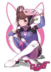 Rule 34 | 1girl, acronym, alternate hairstyle, animal print, blue bodysuit, bodysuit, breasts, brown eyes, brown hair, cellphone, character name, charm (object), clothes writing, d.va (overwatch), emblem, full body, gloves, hair ornament, headphones, high collar, holding, holding phone, hunched over, indian style, konbu (hida123), long hair, one eye closed, outline, outstretched arm, overwatch, overwatch 1, pachimari, phone, pilot suit, rabbit hair ornament, rabbit print, ribbed bodysuit, selfie, shoulder pads, side ponytail, sitting, skin tight, small breasts, smartphone, solo, stuffed animal, stuffed octopus, stuffed toy, taking picture, white background, white gloves