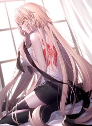 Rule 34 | 1girl, ahoge, ass, back tattoo, bare shoulders, bed sheet, black ribbon, black shorts, black thighhighs, blonde hair, blue eyes, blush, commentary, fate/apocrypha, fate/grand order, fate (series), highres, holding, holding ribbon, indoors, jeanne d&#039;arc (fate), jeanne d&#039;arc (ruler) (fate), long hair, looking at viewer, looking back, mashima saki (mashimasa), ribbon, shirt, shorts, sitting, sleeveless, sleeveless shirt, tattoo, thighhighs, very long hair, white shirt, window