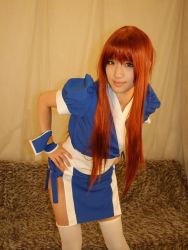 Rule 34 | 1girl, asian, cosplay, couch, curtains, dead or alive, indoors, kasumi (doa), kasumi (doa) (cosplay), leaning forward, long hair, looking at viewer, ninja, pelvic curtain, photo (medium), red hair, saya (cosplayer), solo, tecmo, thighhighs, white thighhighs