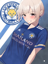 Rule 34 | 1girl, adidas, blonde hair, blue background, blue shirt, blush, breasts, brown eyes, clothes writing, collarbone, commentary request, earrings, grin, highres, idolmaster, idolmaster cinderella girls, jewelry, leicester city fc, logo, looking at viewer, medium breasts, parted bangs, shiomi syuko, shirt, short hair, short sleeves, sidelocks, smile, soccer uniform, solo, sportswear, standing, teeth, trait connection, two-tone background, upper body, white background, yoshimoto (carpsukidayo)