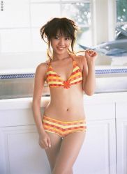 Rule 34 | 1girl, asian, bikini, blurry, breasts, brown hair, counter, depth of field, hasebe yu, indoors, kitchen, looking at viewer, photo (medium), small breasts, smile, solo, standing, swimsuit