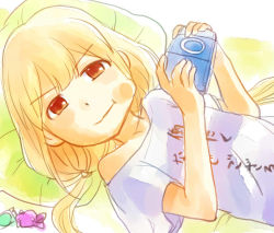 Rule 34 | 10s, 1girl, :t, bare shoulders, blonde hair, candy, cheek bulge, clothes writing, food, futaba anzu, handheld game console, holding, idolmaster, idolmaster (classic), idolmaster cinderella girls, idolmaster one for all, long hair, looking at viewer, lying, on back, orange eyes, piko (pixiv), pillow, playstation portable, shirt, short sleeves, solo, sony, t-shirt, translation request, twintails, white shirt