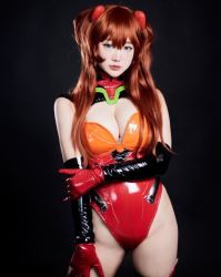 Rule 34 | 1girl, adapted costume, blue eyes, bodysuit, breasts, brown hair, cleavage, cosplay, hair ornament, hand in own hair, hand on own hip, highleg, highleg leotard, interface headset, leotard, lips, long hair, medium breasts, model request, neon genesis evangelion, photo (medium), plugsuit, rebuild of evangelion, red leotard, shiny clothes, simple background, skin tight, smile, solo, souryuu asuka langley, souryuu asuka langley (cosplay), two side up