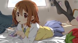 Rule 34 | 1girl, absurdres, black socks, blue ribbon, blue skirt, blush, book, brown eyes, brown hair, closed mouth, commentary request, food, food in mouth, full body, hair between eyes, hair ornament, hairclip, highres, hirasawa yui, indoors, k-on!, kneehighs, long sleeves, looking at viewer, lying, manga (object), medium hair, motchi001, neck ribbon, on bed, on stomach, photo (object), pocky, reading, ribbon, sakuragaoka high school uniform, school uniform, shirt, skirt, socks, solo, strawberry-shaped pillow, sweater vest, white shirt, yellow sweater vest
