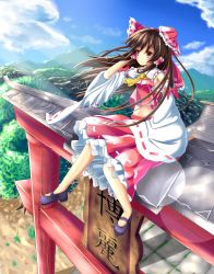 Rule 34 | 1girl, :o, blue sky, blush, bow, brown hair, cloud, day, detached sleeves, frilled skirt, frills, hair bow, hair tubes, hakurei reimu, hand in own hair, highres, leg lift, lens flare, long hair, looking to the side, mary janes, midriff, mountain, navel, outdoors, red eyes, shoes, sitting on torii, skirt, skirt set, sky, solo, torii, touhou, unory, wind