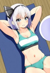 1girl alternate_costume armpits arms_behind_head black_hairband blush breasts buruma cleavage clenched_teeth commentary exercising green_buruma green_sports_bra grey_hair hairband highres hitodama konpaku_youmu konpaku_youmu_(ghost) kyanta5354 lying midriff navel on_back solo sports_bra teeth touhou yoga_mat