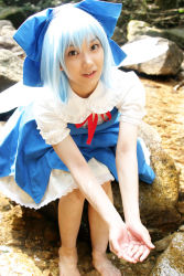 Rule 34 | 1girl, asian, barefoot, blue dress, blue hair, bow, child, circled 9, cirno, cosplay, cosplay photo, dress, feet, highres, lenfried, looking at viewer, looking up, mole, photo (medium), rock, touhou, water, wig, wings