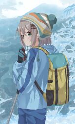 Rule 34 | 1girl, backpack, bag, blue pants, blush, chinosuke (cs4126), closed mouth, female focus, green eyes, grey hair, hair ornament, hairclip, hat, highres, hiking outfit, hiking pole, jacket, looking at viewer, medium hair, mountain, outdoors, pants, solo, standing, winter, winter clothes, winter gloves, yama no susume, yukimura aoi