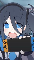 Rule 34 | 1girl, absurdres, aris (blue archive), bedroom, black hair, black hairband, blue archive, blue eyes, blue necktie, blush, commentary, english commentary, grey jacket, gubuos, hair between eyes, hair ornament, hairband, hand up, handheld game console, highres, holding, holding handheld game console, indoors, jacket, long bangs, long sleeves, looking at viewer, meme, necktie, nintendo switch, one side up, open clothes, open jacket, open mouth, photo-referenced, photo background, raised eyebrows, ringed eyes, shirt, solo, upper body, white shirt