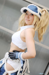 Rule 34 | 1girl, blonde hair, blue eyes, blue mary, chaps, cosplay, gloves, halterneck, halterneck, kof: maximum impact, long hair, midriff, nogu, photo (medium), snk, solo, the king of fighters, twintails