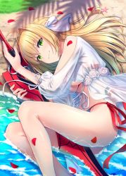 Rule 34 | 1girl, ahoge, bare legs, bare shoulders, beach, between legs, bikini, bikini under clothes, blonde hair, breasts, commentary request, day, fate/grand order, fate (series), flower, green eyes, hair flower, hair intakes, hair ornament, highres, holding, hyuuga azuri, long hair, looking at viewer, nero claudius (fate), nero claudius (fate) (all), nero claudius (swimsuit caster) (fate), nero claudius (swimsuit caster) (third ascension) (fate), petals, see-through, side-tie bikini bottom, sleeves past wrists, solo, string bikini, swimsuit, swimsuit under clothes, sword, umu, underboob, weapon