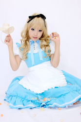 Rule 34 | 1girl, alice (alice in wonderland), alice (alice in wonderland) (cosplay), alice in wonderland, apron, asian, blonde hair, blue eyes, breasts, candy, color contacts, cosplay, food, hair ribbon, kipi-san, long hair, looking at viewer, mole, petite, photo (medium), ribbon, simple background, small breasts, solo, white background