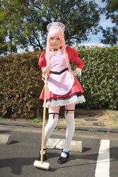 Rule 34 | 1girl, apron, asian, black footwear, blurry, breasts, broom, contrapposto, cosplay, depth of field, dress, garter straps, hand on own hip, hedge, highres, light smile, looking at viewer, maid, maid apron, makeup, mary janes, mascara, namada, nono (top wo nerae 2!), outdoors, parking lot, photo (medium), pigeon-toed, pink hair, puffy sleeves, shoes, short dress, sidelocks, small breasts, solo, standing, thighhighs, top wo nerae 2!, tree, white thighhighs, zettai ryouiki