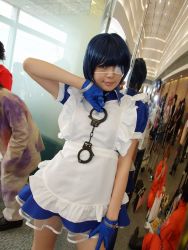Rule 34 | 1girl, apron, asian, blue eyes, blue gloves, blue hair, collar, color contacts, contrapposto, cosplay, cross, cuffs, dutch angle, eyepatch, gloves, handcuffs, ikkitousen, indoors, looking at viewer, maid, maid apron, namada, photo (medium), puffy short sleeves, puffy sleeves, reflection, ryomou shimei, ryomou shimei (cosplay), short sleeves, solo focus, standing