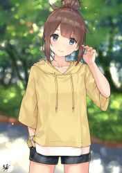 Rule 34 | 1girl, black shorts, blurry, blurry background, blush, brown hair, brown hoodie, closed mouth, collarbone, commentary request, cowboy shot, day, denim, denim shorts, depth of field, drawstring, grey eyes, hair bun, hand in pocket, hand up, highres, hood, hood down, hoodie, miko fly, original, outdoors, shirt, short shorts, shorts, sidelocks, signature, single hair bun, smile, solo, standing, tree, white shirt