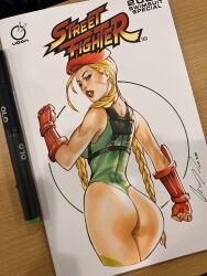 Rule 34 | 1girl, ahoge, antenna hair, artist name, ass, blonde hair, blue eyes, braid, cameltoe, cammy white, elias chatzoudis, facial scar, fingerless gloves, from behind, gloves, green leotard, hat, highleg, highleg leotard, highres, huge ahoge, huge ass, legs apart, leotard, long hair, looking at viewer, looking back, marker (medium), parted lips, photo (medium), revealing clothes, scar, scar on cheek, scar on face, shiny skin, solo, street fighter, thong leotard, traditional media, twin braids, udon entertainment, very long hair, wide hips