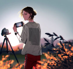 Rule 34 | 1boy, black eyes, black hair, blonde hair, blurry, blurry background, blurry foreground, camera, cellphone, closed mouth, cowboy shot, haikyuu!!, hair bun, holding, holding phone, kozume kenma, looking at viewer, looking back, male focus, multicolored hair, outdoors, phone, plant, profile, shirt, short hair, short sleeves, single hair bun, solo, standing, tripod, twilight, two-tone hair, vgmt, watch, white shirt, wristwatch