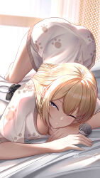 1girl absurdres ass blonde_hair breasts character_doll cleavage evelyn_chevalier gxws highres large_breasts one_eye_closed paw_print paw_print_pattern print_shirt purple_eyes shirt signature solo waking_up wise_(zenless_zone_zero) zenless_zone_zero