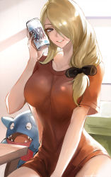 Rule 34 | 1girl, blonde hair, bow, breasts, can, creatures (company), cynthia (pokemon), game freak, gen 4 pokemon, gible, grey eyes, grin, hair bow, hair ornament, hair over one eye, hair over shoulder, highres, holding, holding can, indoors, large breasts, long hair, looking at viewer, nintendo, no pants, orange shirt, parted lips, pokemon, pokemon (creature), pokemon dppt, shirt, short sleeves, side ponytail, smile, t-shirt, tommy (kingdukeee)