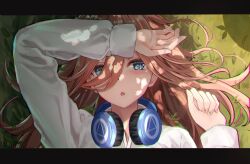 Rule 34 | 1girl, :o, arm up, blue eyes, brown hair, casual, clenched hand, commentary request, dappled sunlight, day, eyelashes, fingernails, go-toubun no hanayome, grass, hair between eyes, hair over one eye, hair spread out, headphones, headphones around neck, highres, light blush, long hair, long sleeves, looking at viewer, lying, nakano miku, on back, on grass, open mouth, outdoors, raikun raikun, shading eyes, shirt, solo, straight-on, sunlight, white shirt