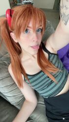Rule 34 | 1girl, arm tattoo, blue eyes, brazilian (nationality), breasts, brown hair, casual, cosplay, hairpods, highres, interface headset, lips, looking at viewer, memepantazis, neon genesis evangelion, photo (medium), selfie, small breasts, solo, souryuu asuka langley, souryuu asuka langley (cosplay), standing, tattoo, tongue, tongue out, twintails, two side up