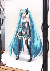 Rule 34 | 1girl, 1other, bare shoulders, black footwear, black pants, black skirt, black sleeves, blue eyes, blue hair, blue nails, blue necktie, blush, boots, brown footwear, camcorder, collared shirt, commentary request, detached sleeves, flying sweatdrops, grey shirt, hair between eyes, hatsune miku, headphones, headset, highres, holding, indoors, long hair, long sleeves, modeling, nail polish, necktie, open mouth, pants, pentagon (railgun ky1206), pleated skirt, shirt, shoes, skirt, sleeveless, sleeveless shirt, sleeves past wrists, solo focus, standing, thigh boots, twintails, v-shaped eyebrows, very long hair, video camera, vocaloid, wide sleeves, wooden floor