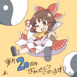 Rule 34 | 1girl, ;d, anniversary, ascot, between fingers, bow, brown eyes, brown hair, commentary request, detached sleeves, dress, gohei, hair bow, hair tubes, hakurei reimu, holding, one eye closed, open mouth, orb, ribbon trim, shoes, simple background, smile, solo, spell card, text focus, touhou, translation request, tsukigi, yellow background, yin yang, yin yang orb