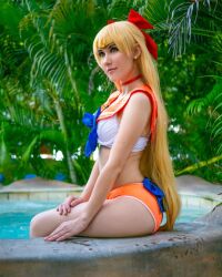 1girl aino_minako ass bikini bishoujo_senshi_sailor_moon blonde_hair breasts cosplay cosplay_photo earrings from_side jewelry long_hair molecularagatha photo_(medium) pool poolside real_life sailor_venus sailor_venus_(cosplay) sitting swimsuit tree very_long_hair water