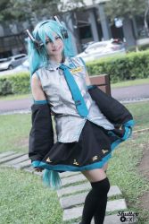 Rule 34 | 1girl, cosplay, female focus, green eyes, green hair, hatsune miku, highres, long hair, matching hair/eyes, nature, necktie, outdoors, photo (medium), plant, skirt, smile, solo, twintails, vocaloid