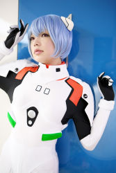 Rule 34 | 1girl, asian, ayanami rei, blue hair, color contacts, cosplay, hairpods, highres, namada, neon genesis evangelion, parted lips, photo (medium), plugsuit, red eyes, short hair, solo, standing