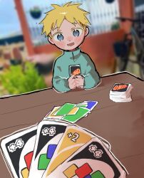 Rule 34 | 1boy, bicycle, blonde hair, blue eyes, blue shirt, blurry, blurry background, blush stickers, butters stotch, card, child, depth of field, highres, holding, holding card, looking at viewer, omochisan216, open mouth, outdoors, outline, playing card, pov, shirt, smile, solo, south park, table, turtleneck, uno (game), white outline