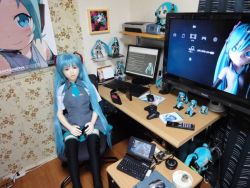 Rule 34 | aqua hair, blue eyes, blue hair, chair, computer, controller, doll, figure, game console, game controller, hatsune miku, keyboard, laptop, long hair, monitor, mouse (computer), mousepad, mousepad (object), otaku room, photo (medium), sex doll, sitting, smile, technology, television, twintails, vocaloid
