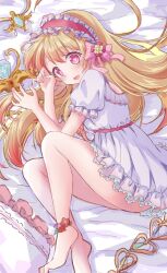 Rule 34 | 1girl, alternate costume, bed, bed sheet, blonde hair, blush, chaos marie (grimms notes), flower ornament, grimms notes, hair ribbon, heart, heart-shaped pupils, highres, jewelry, long hair, lying, necklace, open mouth, pajamas, pillow, pink eyes, ribbon, ronriya3, solo, symbol-shaped pupils, wand, weapon, white pajamas