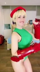 Rule 34 | 1girl, animated, ass, audible music, bare shoulders, bed, black eyes, blonde hair, braid, cammy white, cammy white (cosplay), cosplay, dancing, female focus, fingerless gloves, gloves, green leotard, hat, indoors, leotard, long hair, looking at viewer, one eye closed, panamanian (nationality), photo (medium), red gloves, smile, solo, sound, street fighter, tagme, teeth, thighs, video, window, windygirk