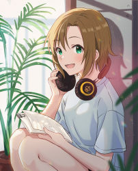 Rule 34 | 1girl, absurdres, adjusting headphones, bare arms, bare legs, binder clip, blurry, blurry foreground, blush, brown hair, commentary request, cowboy shot, curtains, emu (emum), green eyes, headphones, highres, holding, holding paper, idolmaster, idolmaster cinderella girls, indoors, looking at viewer, open mouth, paper, plant, potted plant, shadow, shirt, short hair, short sleeves, smile, solo, squatting, t-shirt, tada riina, white shirt