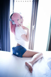 Rule 34 | 1girl, ass, barefoot, brown eyes, cosplay, cosplay photo, curtains, denim, denim shorts, from side, headphones, highres, legs, long hair, looking at viewer, midriff, nitroplus, photo (medium), pink hair, shirt, short shorts, shorts, sitting, smile, soles, solo, super sonico, super sonico (cosplay), toes, window