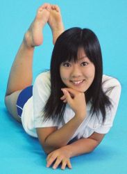 Rule 34 | blue background, feet up, hand rest, idol, lying, miku nakanishi, nakanishi miku, on stomach, photo (medium), short shorts, shorts, smile, the pose