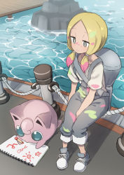 Rule 34 | 1girl, aged down, bag, blonde hair, closed mouth, commentary, crayon, creatures (company), duffel bag, facepaint, game freak, gazacy (dai), gen 1 pokemon, grey eyes, highres, jigglypuff, long hair, low twintails, mina (pokemon), nintendo, overalls, paint, paint splatter, pokemon, pokemon (creature), pokemon lgpe, rope, shirt, shoes, short sleeves, sitting, sketchbook, smile, twintails, water, white shirt