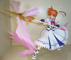 Rule 34 | 00s, 1girl, :d, blue eyes, bow, bowtie, energy wings, figure, fingerless gloves, full body, gloves, hair ribbon, holding, holding weapon, lance, long sleeves, lyrical nanoha, magazine (weapon), magic circle, magical girl, mahou shoujo lyrical nanoha, mahou shoujo lyrical nanoha a&#039;s, octagram, open mouth, orange hair, photo (medium), polearm, purple eyes, raising heart, red bow, red hair, ribbon, shoes, short hair, smile, solo, takamachi nanoha, twintails, weapon, winged footwear, wings