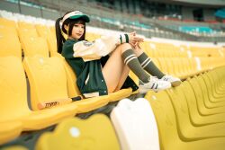 Rule 34 | 1girl, arena, asian, baseball bat, baseball cap, chair, chinese (nationality), chunmomo0127, feet on chair, green baseball cap, green jacket, hat, jacket, looking at viewer, outdoors, oversized clothes, oversized jacket, own hands clasped, photo (medium), real life, red lips, shoes, sitting, smile, sneakers, thighs, unbuttoned, unbuttoned jacket, white chair, white footwear, yellow chair