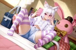 1girl absurdres animal_ear_fluff animal_ears blush bow cat_ears cellphone denim denim_shorts feet flat_chest heart heart-shaped_pillow highres hood hoodie kairunoburogu legs midriff_peek on_bed original phone pillow plaid_bow plaid_pillow purple_eyes short_hair shorts sitting smile socks solo spread_legs striped_clothes striped_socks striped_thighhighs stuffed_animal stuffed_toy thighhighs thighs toes v white_hair white_hoodie