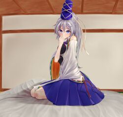 Rule 34 | 1girl, blue eyes, blue hat, blue skirt, closed mouth, commentary request, full body, grey hair, hat, highres, indoors, long hair, looking at viewer, mikotouca, mononobe no futo, pom pom (clothes), ponytail, ribbon-trimmed sleeves, ribbon trim, sitting, skirt, smile, solo, tate eboshi, touhou, variant set