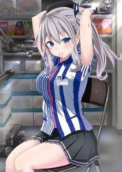 Rule 34 | 10s, 1girl, adjusting hair, armpit peek, arms behind head, arms up, beret, black skirt, blue eyes, blush, box, chair, clerk, collared shirt, employee uniform, folding chair, hair tie, hat, highres, indoors, kantai collection, kashima (kancolle), kuroame (kurinohana), lawson, legs together, light particles, long hair, looking at viewer, machinery, mouth hold, name tag, pleated skirt, shelf, shirt, short sleeves, sidelocks, silver hair, sitting, skirt, solo, striped clothes, striped shirt, turret, twintails, tying hair, uniform, vertical-striped clothes, vertical-striped shirt, wavy hair