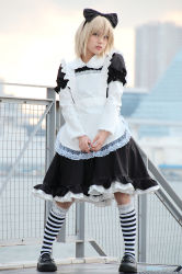 Rule 34 | 1girl, apron, artist request, asian, black bow, black footwear, blonde hair, blurry, bow, cosplay, cosplay request, day, depth of field, facing viewer, full body, hair bow, loafers, looking at viewer, maid, maid apron, outdoors, photo (medium), railing, real life, scary eyes, shoes, socks, solo, standing, striped clothes, striped socks, v arms, white apron, wig